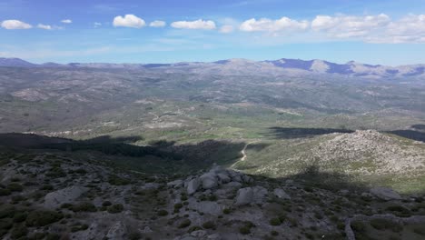 flight-with-impressive-views-where-we-see,-in-this-order,-an-enclosed-stone-enclosure-for-cattle,-the-sacred-stones,-the-hermitage-of-San-Pedro-and-the-Visigoth-negropolis-in-Navarrevisca,-Avila