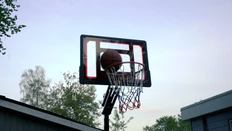 Steady-shot-of-a-basketball-hoop-and-throwing-a-ball-against-the-back-board-missing-the-net