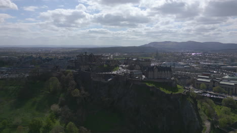 Aerial-Orbit-of-Edinburg-City-and-Castle-on-Rocky-Outcrop---Sunny-Day