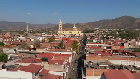 Aerial-dolly-in-flight-overlooking-a-residential-area-and-the-Santuario-Diosesano-in-Tamazula-de-Gordiano