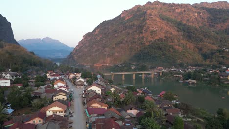 drone-shot-of-dirt-road-in-remote-village-in-the-mountain-town-of-Nong-Khiaw-in-Laos,-Southeast-Asia