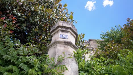 Slow-revealing-shot-of-a-chateau-number-on-the-outside-of-a-stone-wall