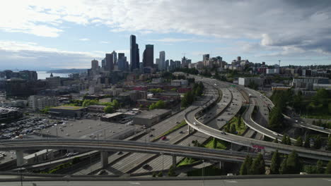 Aerial-tracking-shot-of-traffic-on-interstate-90-and-the-Seattle-skyline,-in-USA