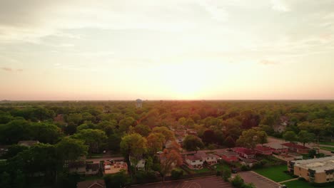 Aerial-view-of-Chicago-suburban-houses-and-greenery-during-sunset,-showcasing-a-peaceful-residential-area