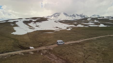 Autocaravana-Conduce-En-Un-Paisaje-Montañoso-De-Montañas-Nevadas