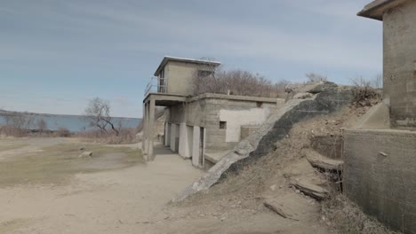 Old-war-time-bunker-and-ocean-lookout-on-the-rocky-shores-of-the-Atlantic-Ocean-in-Portland-Maine-during-a-overcast-day-in-4k