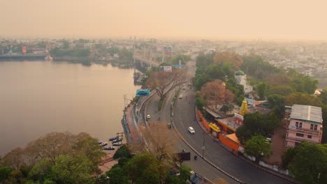 Aerial-drone-shot-of-bhopal-capital-city-of-madhya-pradesh-with-upper-lake-and-downtown-roads-with-car-traffic-in-india