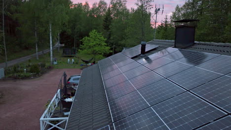 Módulos-Fotovoltaicos-Que-Recogen-Electricidad-En-Una-Casa-Familiar,-Atardecer-De-Verano---Vista-Aérea