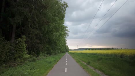 Travelling-isolated-countryside-narrow-road,-route-through-Mother-Nature