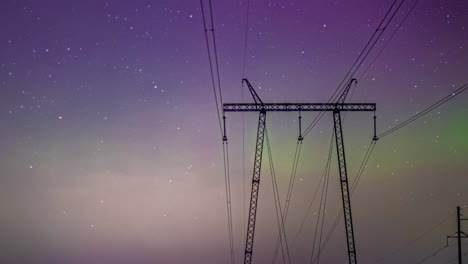 Aurora-Borealis-and-night-starry-sky-above-high-voltage-power-lines,-time-lapse