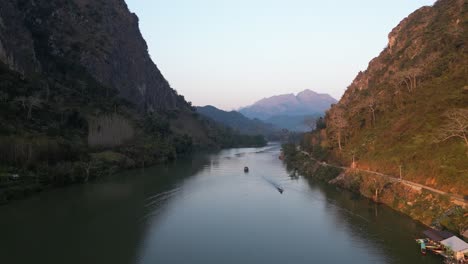 drone-shot-of-river-valley-in-the-mountain-town-of-Nong-Khiaw-in-Laos,-Southeast-Asia