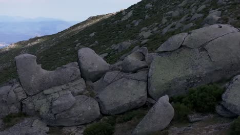 lateral-flight-with-a-drone-visualizing-a-striking-group-of-consecutive-stones-creating-a-parallax-effect-by-filming-in-70mm-the-set-ends-in-a-large-ceremonial-stone-Navarrevisca-Avila