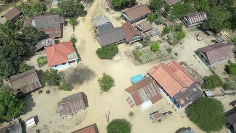 aerial-drone-shot-of-dirt-roads-in-remote-village-in-the-mountain-town-of-Nong-Khiaw-in-Laos,-Southeast-Asia