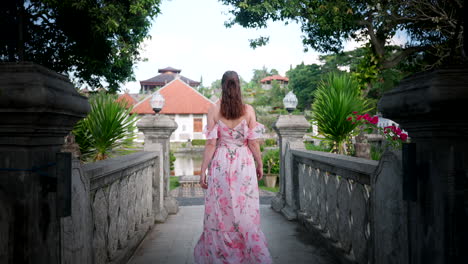 Traveller-in-summer-dress-explore-beautiful-grounds-of-Sukasada-Park,-Bali