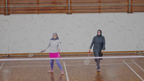 Young-Asian-Muslim-Women-Wear-Sport-Hijab-Playing-Badminton-In-Double-Match-At-Indoor-Court