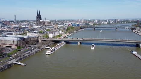 Urban-River-Cityscape-and-Cologne-Landmarks-Skyline,-Drone-View