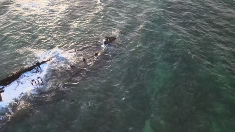 Drone-aerial-turning-and-spinning-over-a-shipwreck-in-the-ocean