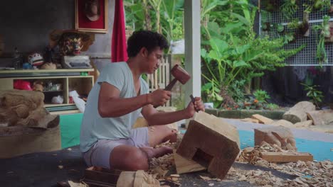 Man-Making-Wooden-Craft---Barong-Mask-Carving-In-Bali,-Indonesia---Wide-Shot