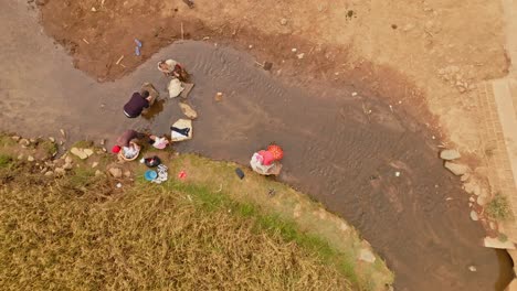 Poor-Malagasy-people-doing-laundry-in-an-African-river---aerial-top-down-view