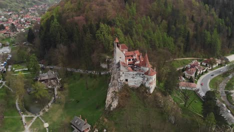 Countryside-castle-landscape,-aerial-drone-fly-green-forested-Dracula's-village