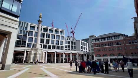 Group-Of-People-At-Paternoster-Square-Beside-St-Paul's-Cathedral-On-Sunny-Morning-With-Construction-Cranes-In-Background