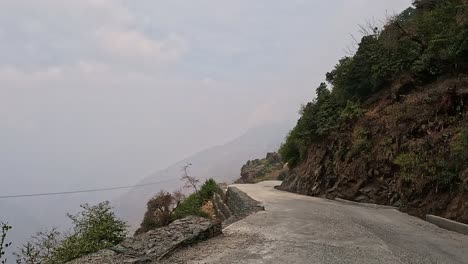 View-driving-along-a-dangerous-mountain-road-with-steep-slopes-downwards