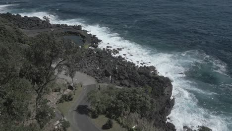 People-at-rocky-natural-pool-along-Santo-Antonio-coast,-Sao-Miguel-Island,-Azores-in-Portugal