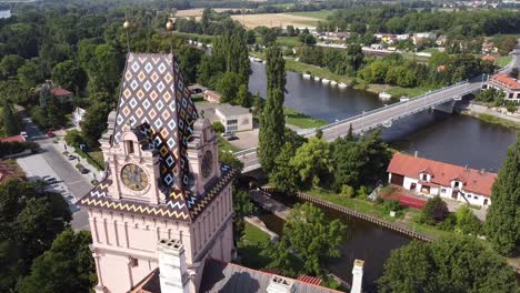 Drone-view-captures-Brandýs-nad-Labem-castle-with-town-view,-road,-river,-lush