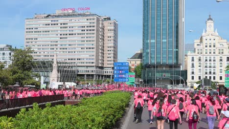 A-sea-of-pink-shirted-participants-floods-the-streets,-coming-together-for-the-Women's-Race-and-advocating-for-metastatic-breast-cancer-awareness-in-Madrid,-Spain