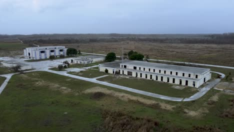 Slow-aerial-ascend-over-abandoned-military-base-and-Voice-of-America-radio-station-headquarters-in-Greece