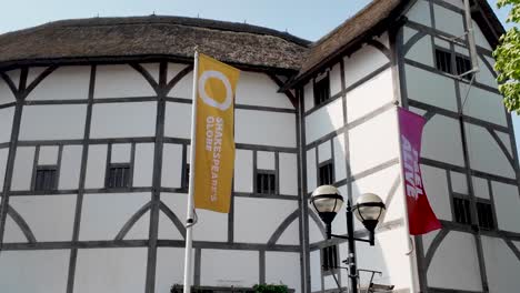 Shakespeare's-Globe-Theatre-in-London-with-colorful-flags-on-a-sunny-day