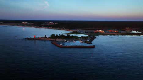 Drone-orbiting-the-Keskuskari-island,-sunset-in-Kalajoen-hiekkasarkat,-Finland