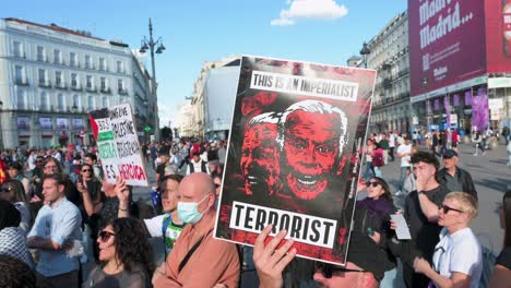 A-protester-holds-a-placard-depicting-U