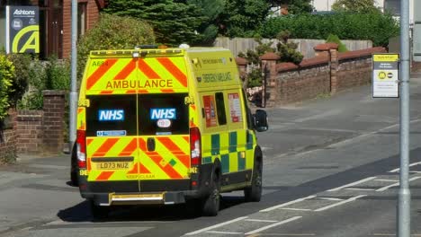 Police-and-ambulance-attending-road-traffic-incident-in-British-neighbourhood