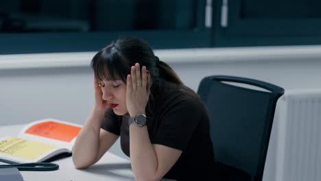 Young-beautiful-woman-with-dark-hair-throwing-glasses-away,-working-hard-and-being-stressed-and-burned-out-in-office