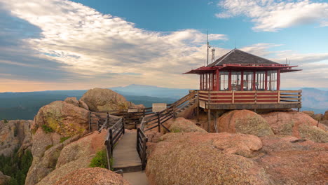 Timelapse,-Devil's-Head-Fire-Lookout-Building-on-Top-of-Summit-Above-Rocky-Mountains-Landscape-and-Horizon,-Pike-National-Forest-Colorado-USA