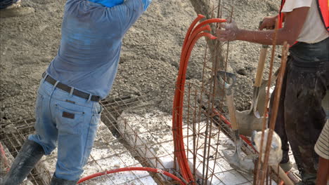 Slow-motion-of-a-mexican-latin-construction-worker-using-a-boom-pump-to-apply-concrete-mix-on-a-grid-with-styrofoam-to-build-the-slab-flooring-of-a-new-house-in-Mexico
