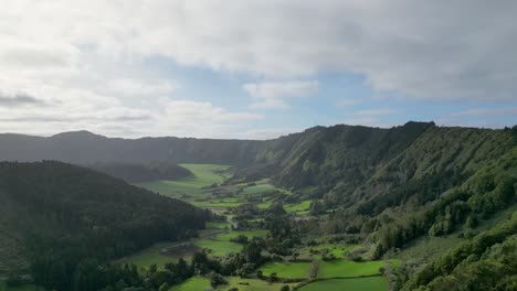 Aerial-view-of-well-kept-green-valleys-bathed-in-sunlight-on-a-cold-morning-in-Terceira,-Azores
