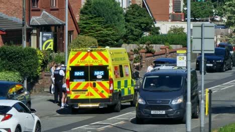 Police-and-paramedic-ambulance-attending-serious-road-traffic-incident-in-British-neighbourhood