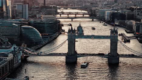 Approaching-Pan-Down-Drone-Shot-of-Tower-Bridge-at-Sunset-with-Traffic-and-Boat