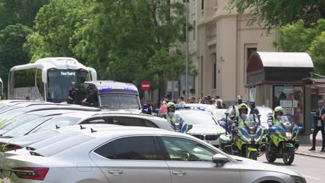 The-Real-Madrid-team-and-bus,-escorted-by-police,-arrive-at-the-reception-as-part-of-the-celebration-of-winning-the-36th-Spanish-soccer-league-title-in-Madrid,-Spain