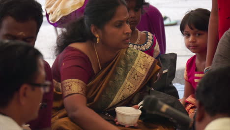 Hindu-woman-participates-in-ritual-at-festival-honoring-the-deity,-Ganesh