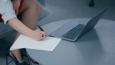 Close-up-of-a-woman's-hand-working-writing-information-down-on-the-paper-in-slow-motion