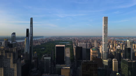 Billionaires-row-skyscrapers-with-Central-Park-background,-golden-hour-in-NYC---Aerial-tracking-shot