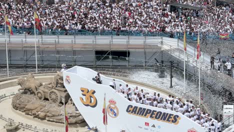 Real-Madrid-players-celebrate-their-36th-Spanish-football-league-championship,-the-La-Liga-title,-with-fans-at-Cibeles-Square,-where-thousands-of-fans-gathered-in-Madrid,-Spain