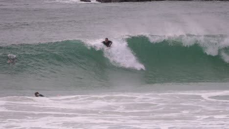 A-surfer-catching-a-medium-sized-wave,-Duranbah-Beach,-Southern-Gold-Coast