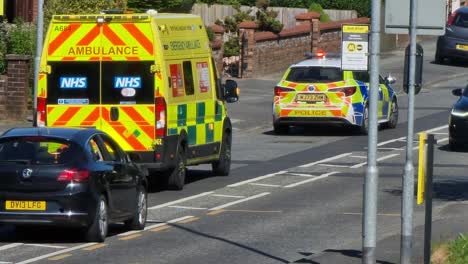 Police-and-paramedic-ambulance-attending-urgent-road-traffic-incident-in-British-neighbourhood