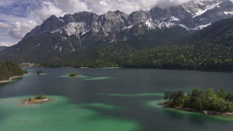 Panoramic-aerial-view-of-the-famous-Eibsee-Lake,-at-the-foot-of-the-Zugspitze-mountain,-the-highest-peak-in-Germany