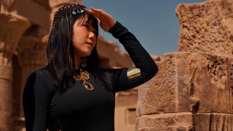 Female-Tourist-in-Traditional-Clothing-at-Philae-temple-complex,-Philae-Island