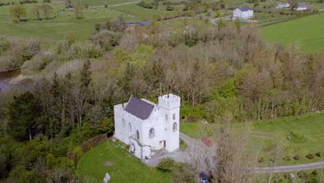 Cloud-shadow-recedes-over-Cargin-Castle-overlooking-lake,-Ireland